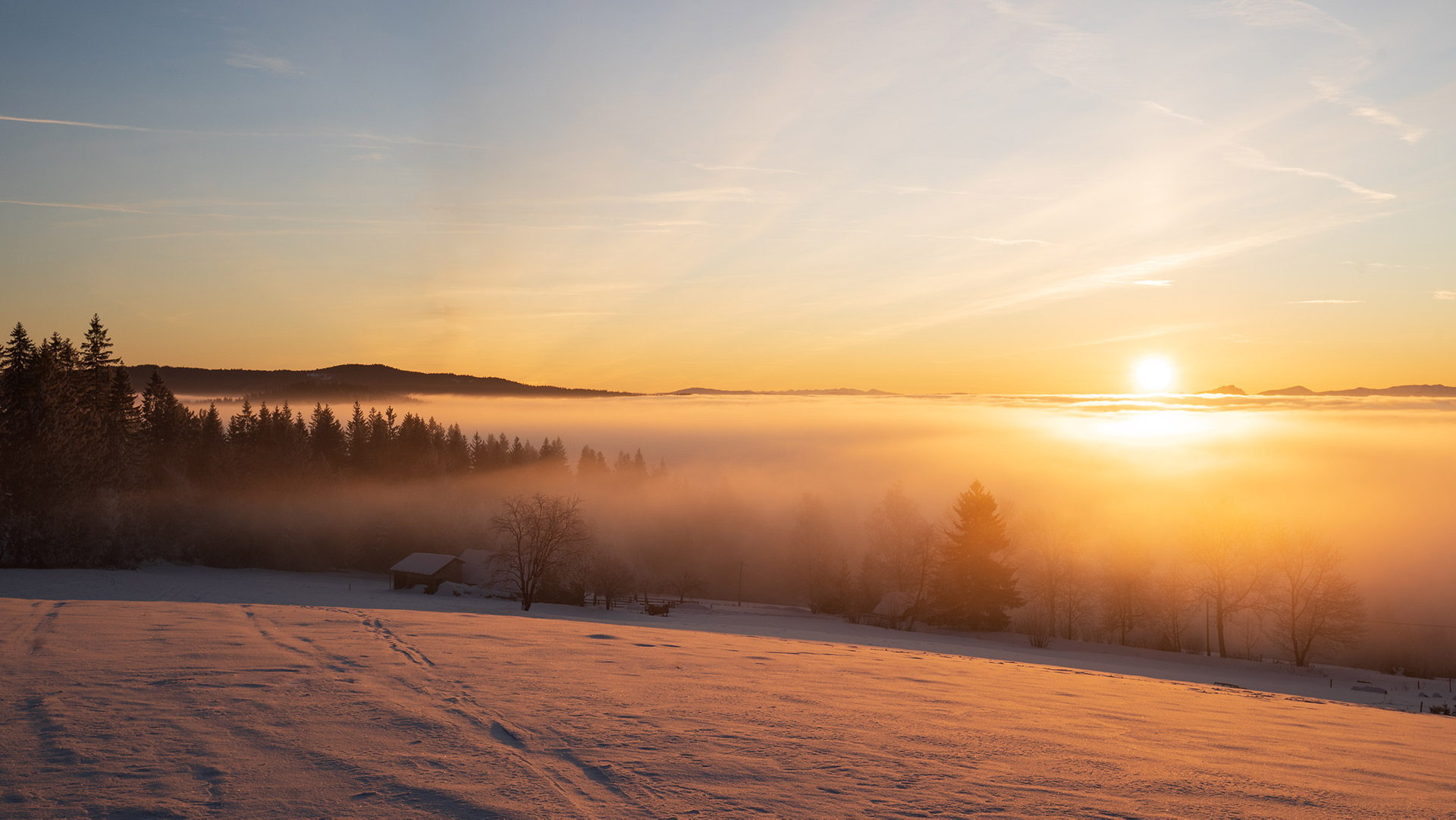 Sunrise on a cold morning over foggy hills